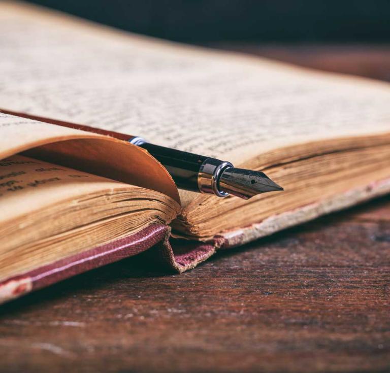 Old book and pen